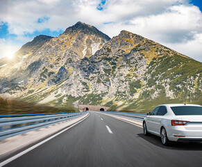 Picturesque road in the mountains and a white car.