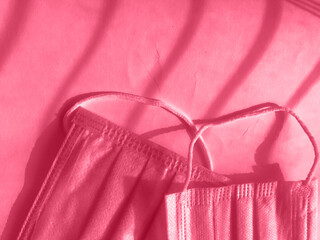 Vitamins and doctor's mask, corona virus protection concept isolated on gray background. Respiratory medical mask and pills. Fresh classic 2023 in blue. Color concept of the year.