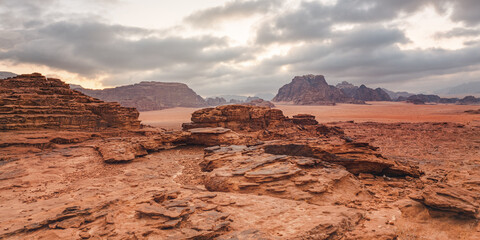 Red orange Mars like landscape in Jordan Wadi Rum desert, mountains background, overcast morning....
