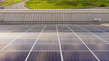 Aerial view of solar panels installed on the roof of an industrial building. Solar energy...