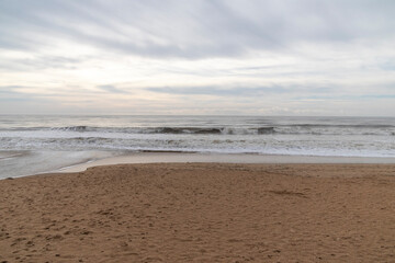 Frontal views of waves from the beach. A cloudy day.