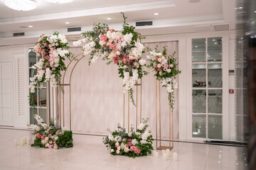Fototapeta na wymiar Arch for the wedding ceremony, decorated with white and pink flowers.