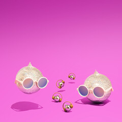 Shiny disco balls and baubles with headphones and sunglasses on a purple background. Concept of Christmas, New Year and winter holidays party, music and happiness. Good Vibes.