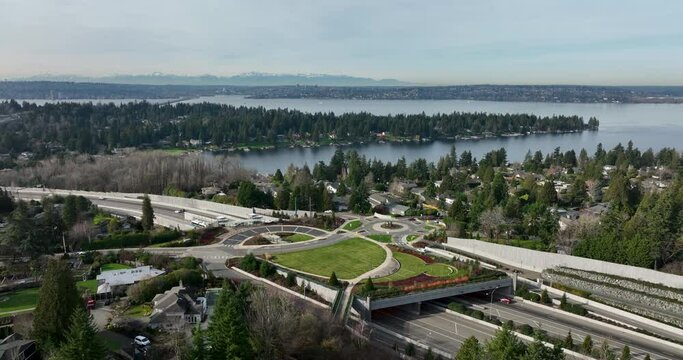 Aerial View of Roundabout Overpass with Park in Hunts Point Washington Above the 520 Freeway Traffic With Majestic Views of Seattle and the Olympic Mountains