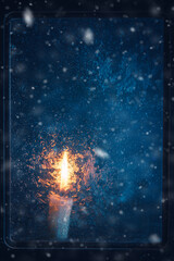 Christmas, new year, winter composition. Candle behind a frozen window