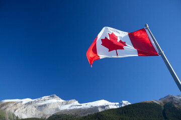 canadian flag with mountain backdrop