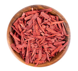 Red Sandalwood incense chips in wooden bowl, isolated on white background. Sanderswood, rubywood or...