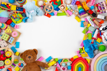Baby kids toys frame. Set of colorful educational wooden, plastic and fluffy toys on white background. Top view, flat lay