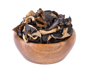 Dry black fungus in wooden bowl, isolated on white background. Chinese black mushroom or tree black muer mushroom. Auricularia polytricha.