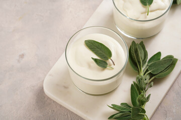 Creamy dairy yoghurt dessert sweet mousse with mascarpone, cream cheese, sage and lemon juice in...