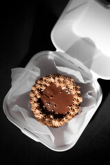 Small bento cake as a gift for the holiday on dark background. Style cakes in a box for one person