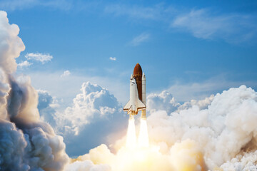Spaceship lift off. Space shuttle with smoke and blast takes off into space on a background of blue...