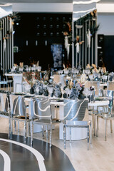 Wedding dining table decorated with flowers and candles. Place for guest on the wedding. Wedding table setting