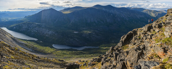 Two women exploring the mountains and wilderness of the Yukon. Feeling alive and vibrant in the beautiful scenery around Haines Junction; Yukon, Canada