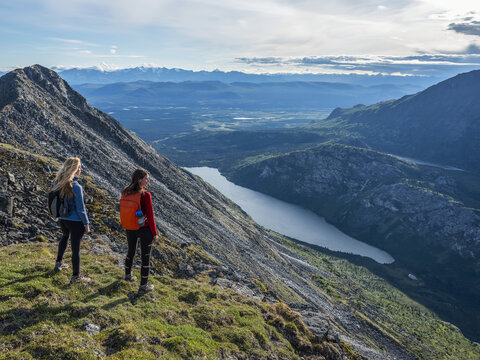 Two women exploring the mountains and wilderness of the Yukon. Feeling alive and vibrant in the beautiful scenery around Haines Junction; Yukon, Canada