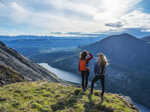 Two women exploring the mountains and wilderness of the Yukon. Feeling alive and vibrant in the beautiful scenery around Haines Junction; Yukon, Canada