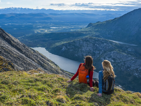 Two women exploring the mountains and wilderness of the Yukon. Feeling alive and vibrant in the beautiful scenery around Haines Junction; Yukon, Canada