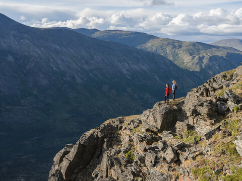 Two women exploring the mountains and wilderness of the Yukon. Feeling alive and vibrant in the beautiful scenery around Haines Junction; Yukon, Canada