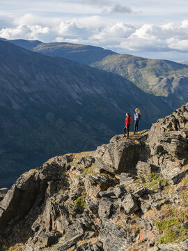 Two women exploring the mountains and wilderness of the Yukon. Feeling alive and vibrant in the beautiful scenery around Haines Junction; Yukon, Canada