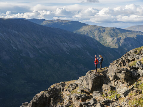 Two women exploring the mountains and wilderness of the Yukon. Feeling alive and vibrant in the beautiful scenery around Haines Junction; Yukon, Canada