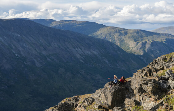 Two women exploring the mountains and wilderness of the Yukon. Feeling alive and vibrant in the beautiful scenery around Haines Junction; Yukon, Canada