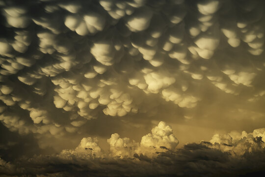 Dramatic skies over the landscape seen during a storm chasing tour in the midwest of the United States. An example of mammatus cloud; Kansas, United States of America
