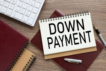 Down payment top view on notepads. text on torn page