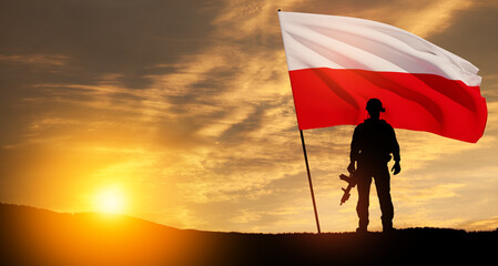 Silhouette of soldier with national flag on background of sunset. Polish Armed Forces. Armed Forces of the Republic of Poland. Polish army.