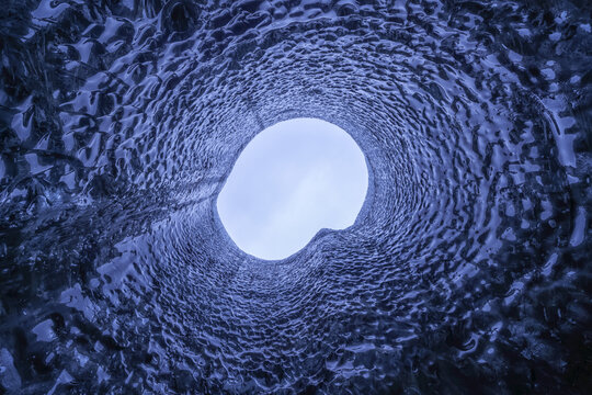 Looking straight up a hole in the roof of the ice cave; Iceland