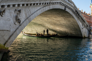 Fototapeta na wymiar Two Gandola passing under the famous Rialto Bridge in Venice, Italy.