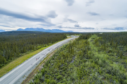 The mountains near Haines Junction during summer in the Yukon. Bikers ride along the Haines Highway during the annual Haines to Haines bike relay; Haines Junction, Yukon, Canada