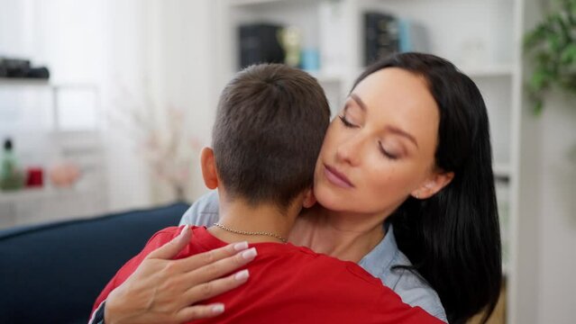 Sad mother hugging her son, close relationship, mom's support, problems