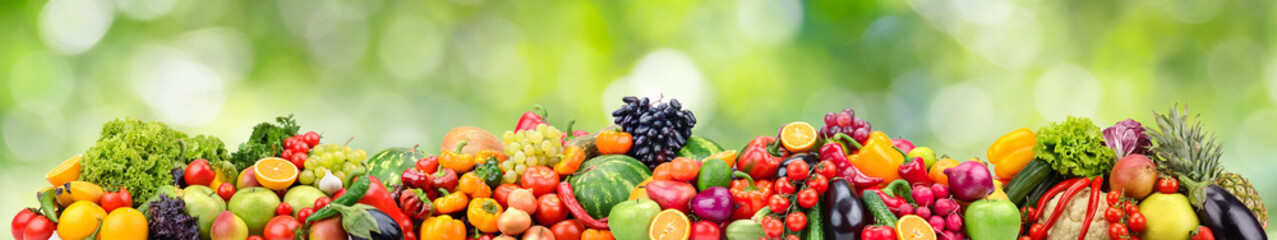 Fototapeta na wymiar Bright berries, fruits and vegetables on green