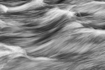 Image of water flowing in a long exposure in the Klondike River; Dawson City, Yukon, Canada