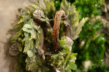 Green fir wreath on the wall at christmas market store for home interior decoration