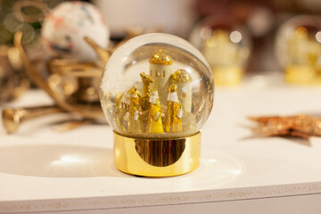 Shiny festive golden snow globes with three kings to celebrate Spanish traditional holiday on the...