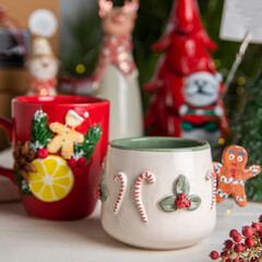 christmas decorated ceramic coffee cups with gift boxes and christmas tree