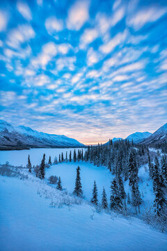 Stunning snowy landscape with sunrise over Annie Lake in Winter; Whitehorse, Yukon, Canada