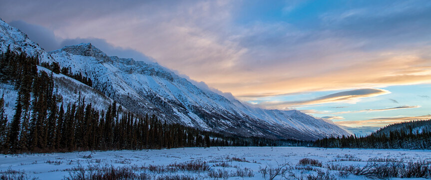 Sunset over the Grey Ridge mountains above Annie Lake in winter; Whitehorse, Yukon, Canada