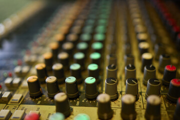 View of music mixer in concert, filled with lights.