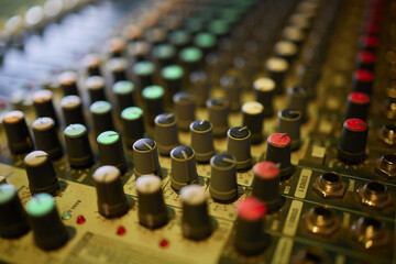 View of music mixer in concert, filled with lights.