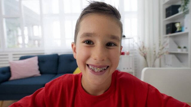 Portrait of smiling schoolboy wearing braces, healthy teeth, happy childhood