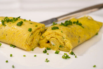 French Chives Omelette, Runny or Baveuse Eggs with Green Herbs on a White Plate