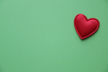 Red heart on a green background. Place for text. Valentine.