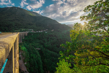 Famous bridge on the Tara river in Montenegro or Crna gora in evening sun, called Đurđeviča. Colossal bridge spaning over Tara river, concrete arches crossing the span..