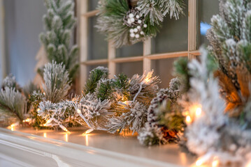 Winter holiday background with white lights on a flocked garland