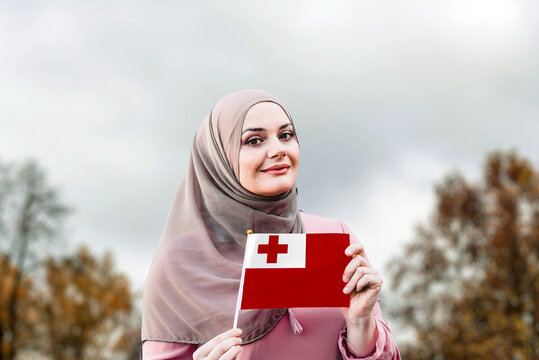 Muslim Woman In Hijab Holds Flag Of Tonga
