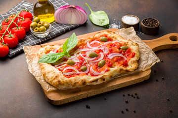 Pizza marinara on dark brown table, pinsa
