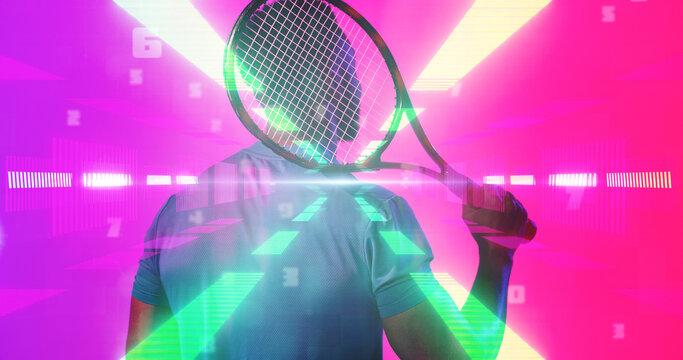 Rear view of african american tennis player holding racket over illuminated light rays, copy space