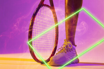 Cropped leg of african american male tennis player with racket by illuminated triangle